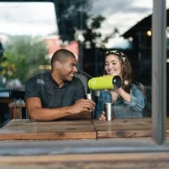 Klean Kanteen Insulated TK Wide With Café Cap 946ml - Black -Vango || Kampa || Outwell Sales Store K32TKWSSL JP bottle brewery pouring lifestyle 1